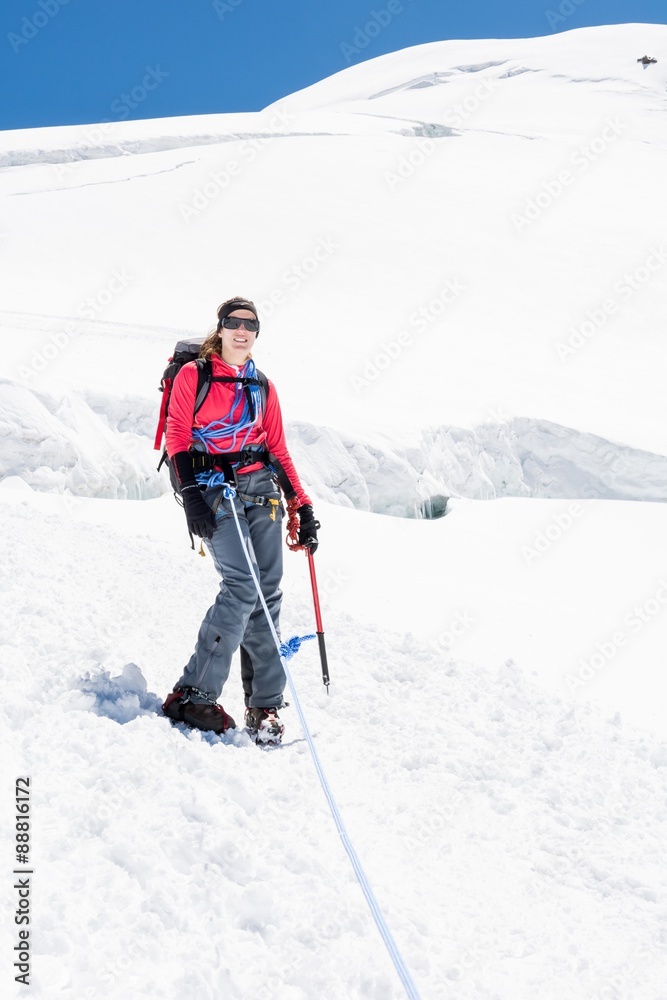 Female alpinist standing on glacier.