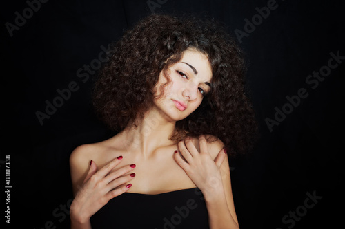 curly girl with red manicure closeup