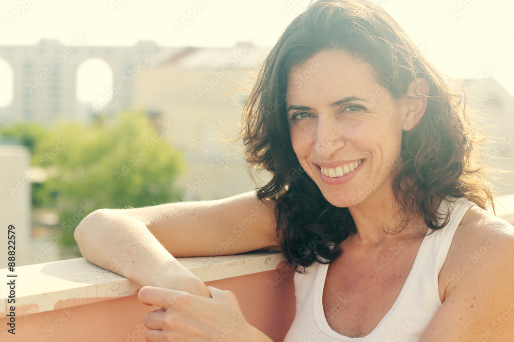 Fototapeta premium Portrait of beautiful 35 years old woman on sunset colors