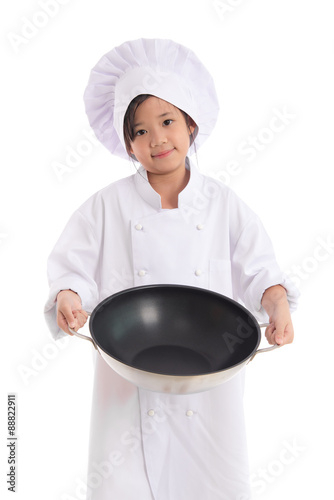 Little asian girl in chef uniform holding the frying pan,isolated on white photo