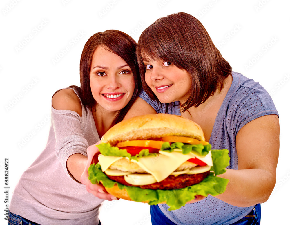 Women eating hamburger.