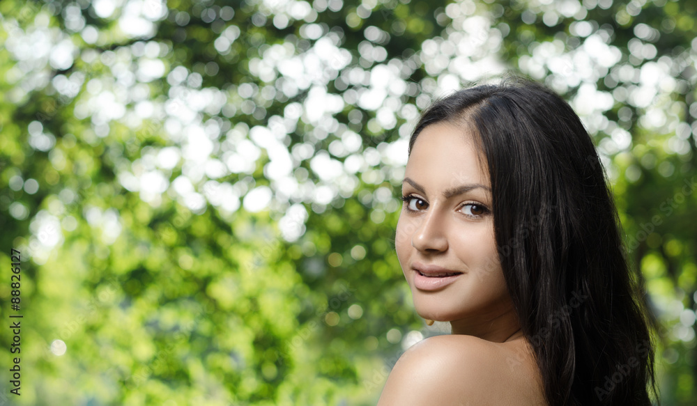 Portrait of a young brunette on nature background Portrait of a young brunette on nature background