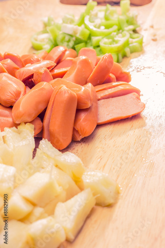 Preparing a stir fry of stewed vegetables and sausage photo