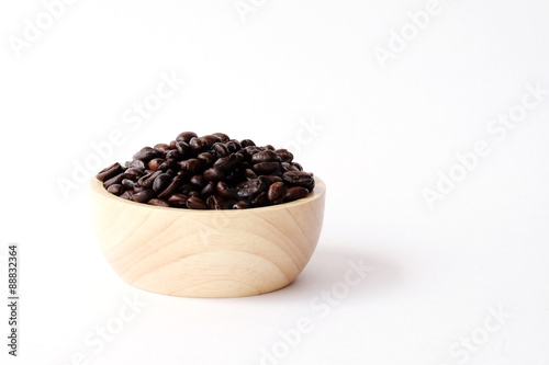 Coffee beans in wooden bowl isolated on white background