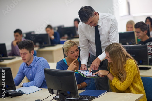 students with teacher  in computer lab classrom