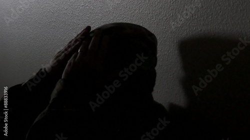 A soldier's silhouette rests against a hallway wall, Close up, 4K