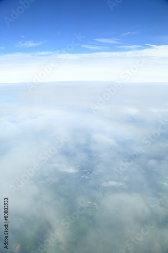 Rainbow which suits cloud roundly. Japan seen from the sky.