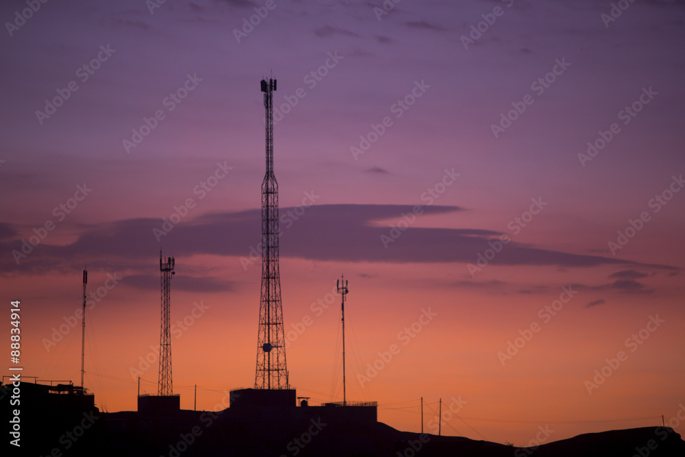Communication towers on orange purple sky background, Peru