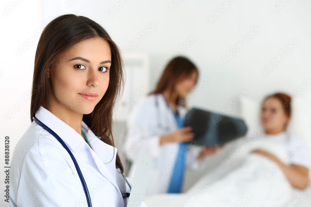 Beautiful female medicine doctor looking in camera Beautiful female medicine doctor looking in camera