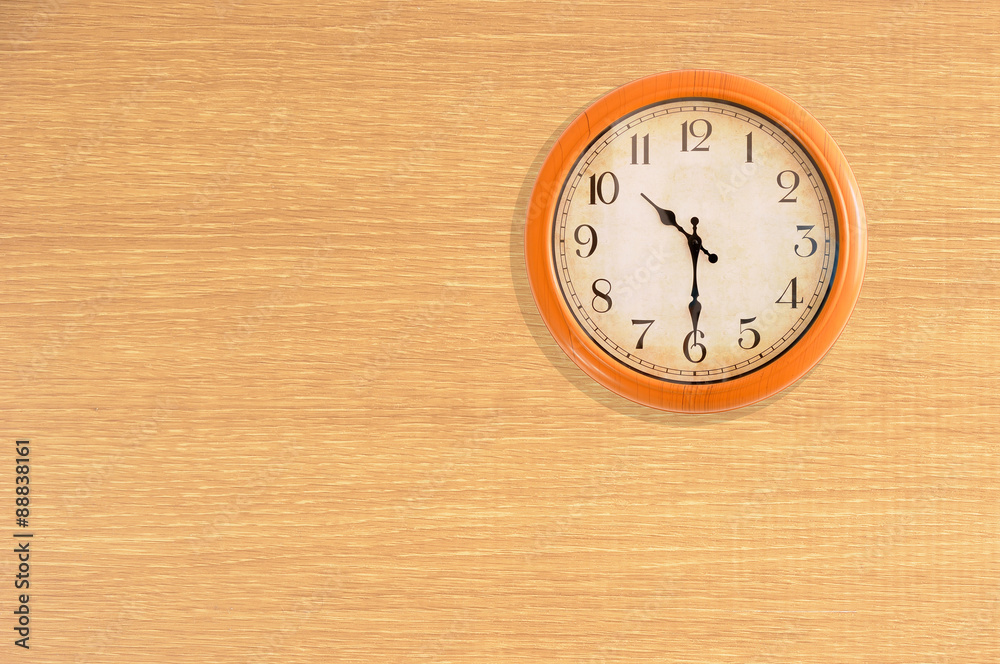 Clock showing 10:30 o'clock on a wooden wall Clock showing 10:30 o'clock on a wooden wall