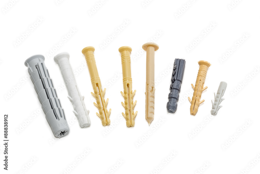Several plastic wall plugs on light background