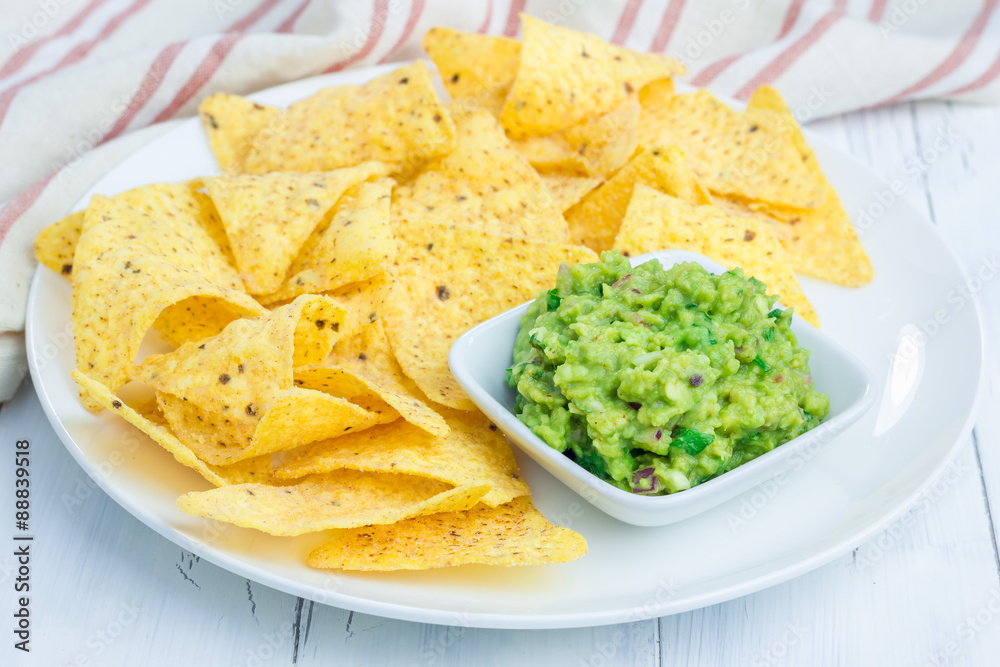 Cup with chunky guacamole served with nachos Cup with chunky guacamole served with nachos