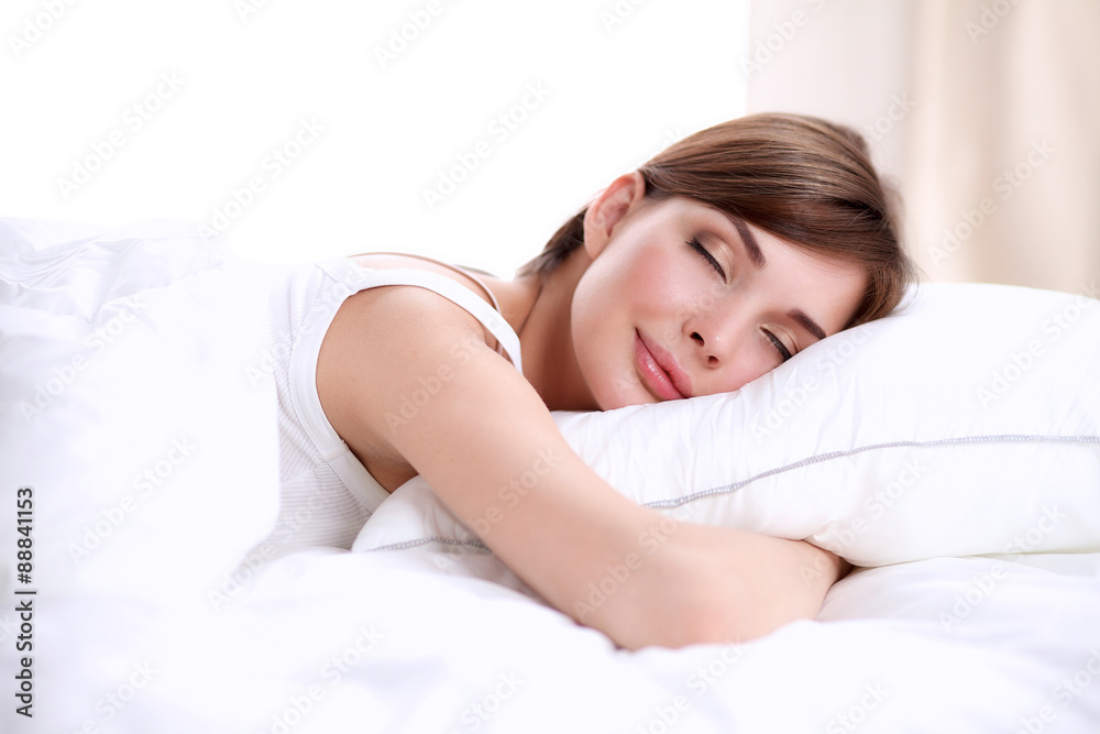 Beautiful girl sleeps in the bedroom, lying on bed Beautiful girl sleeps in the bedroom, lying on bed