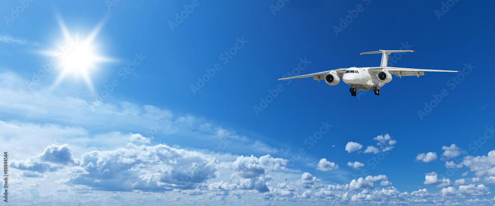White heap clouds, airplane and bright sun in the blue sky. White heap clouds, airplane and bright sun in the blue sky.
