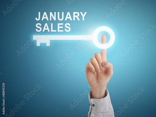 male hand pressing January sales key button