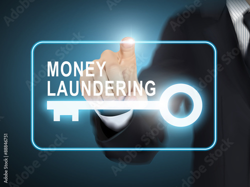 male hand pressing money laundering key button