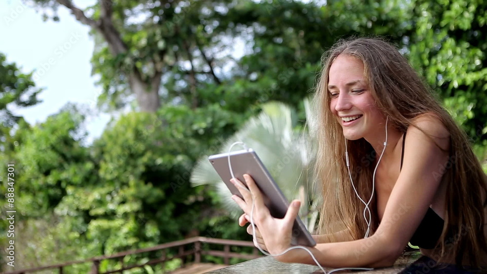 Beautiful young woman using video chat on tropical vacation Beautiful young woman using video chat on tropical vacation