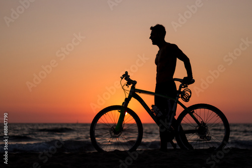 at sunset silhouette of a sportsman on a bike