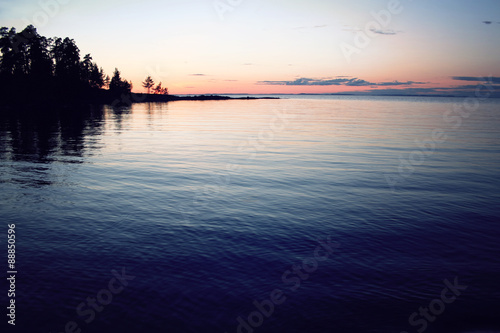Trees reflected in the water. Beautiful northern landscape. © Lora Sutyagina