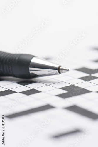 Crossword puzzle and pen