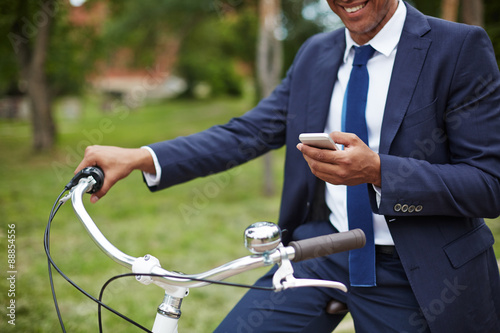 Man with cellphone and bicycle