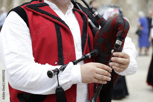 Detail of a man playing the Galician bagpipe, dressed in a traditional costume of Galicia, northwestern Spain photo