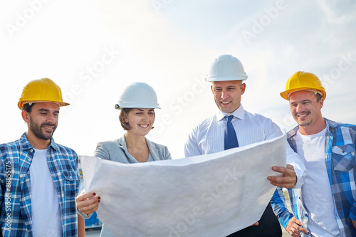 group of builders and architects with blueprint photo