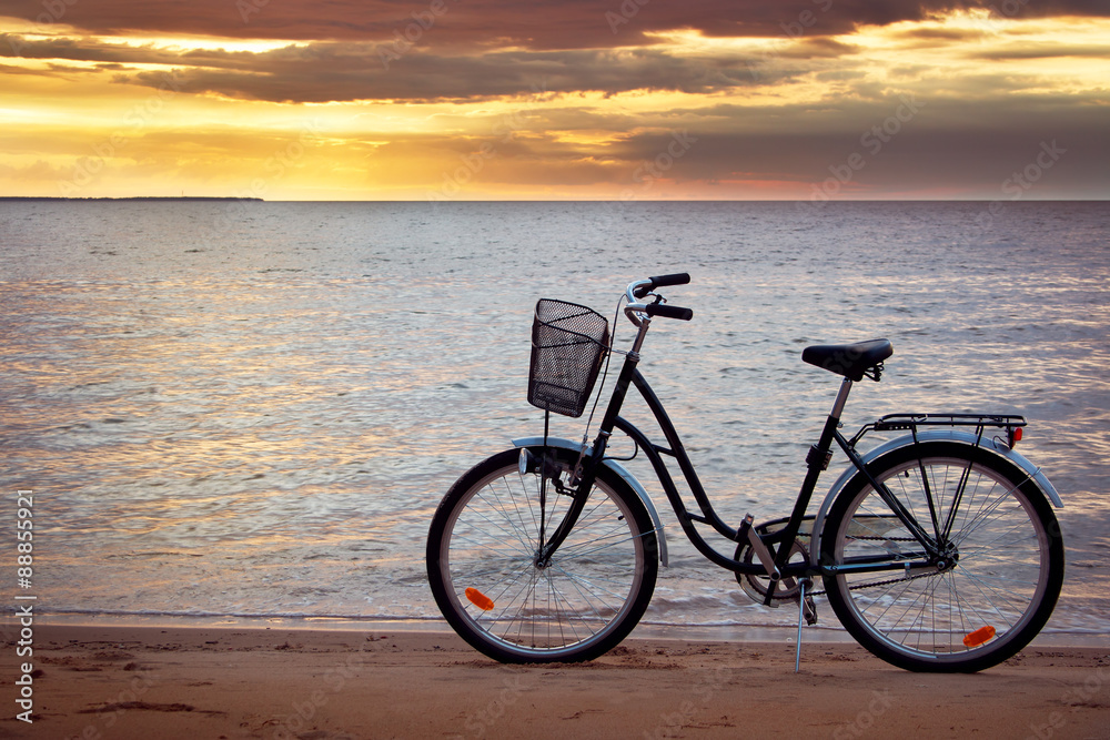 Lonely bike standing at sunset