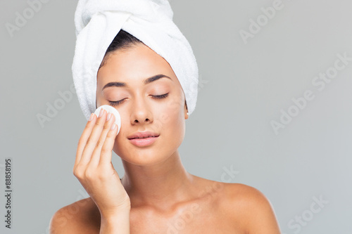 Woman with towel on head holding wadded disk