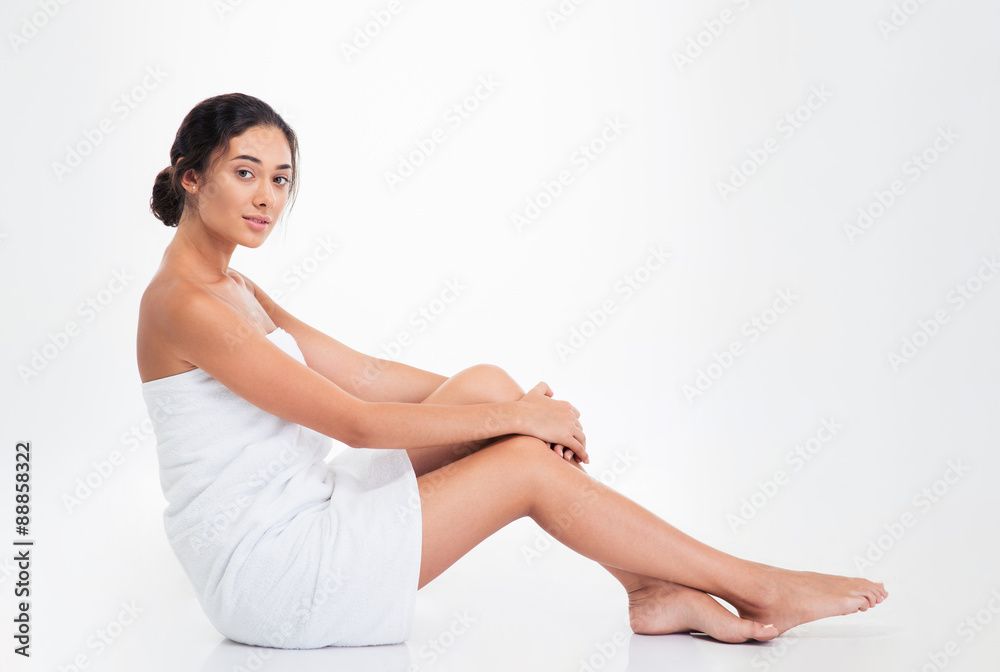 Beautiful young woman in towel sitting on the floor Beautiful young woman in towel sitting on the floor
