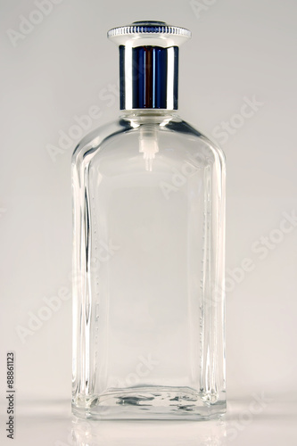 An empty perfume transparent bottle isolated on a white background