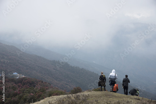 the travellers are standing on the mountain in Pool Hill, Nepal