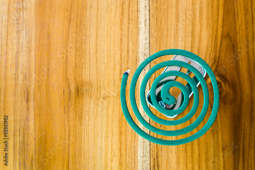 Mosquito repellent is placed on a wooden floor. photo