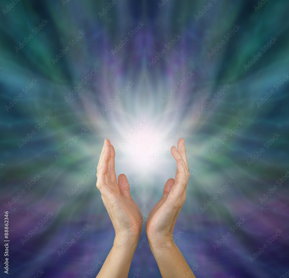 Sensing Healing Energy - Female healing hands reaching up to white light  emerging from radiating green and purple ethereal energy formation  background with copy space above. Stock Photo | Adobe Stock