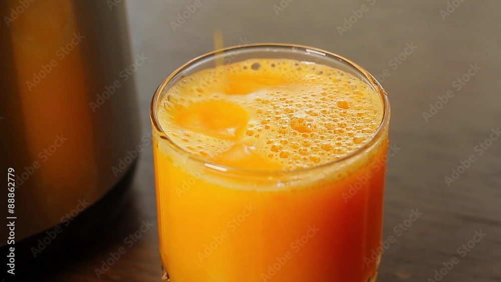 Preparation of orange juice. Drops fall into a glass of juice. Preparation of orange juice. Drops fall into a glass of juice.