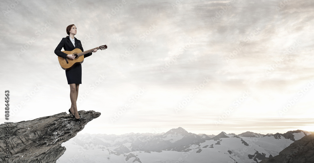 Businesswoman playing acoustic guitar Businesswoman playing acoustic guitar