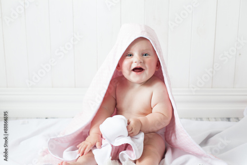 Obraz na płótnie happy baby with a towel after the shower in bed at home w salonie