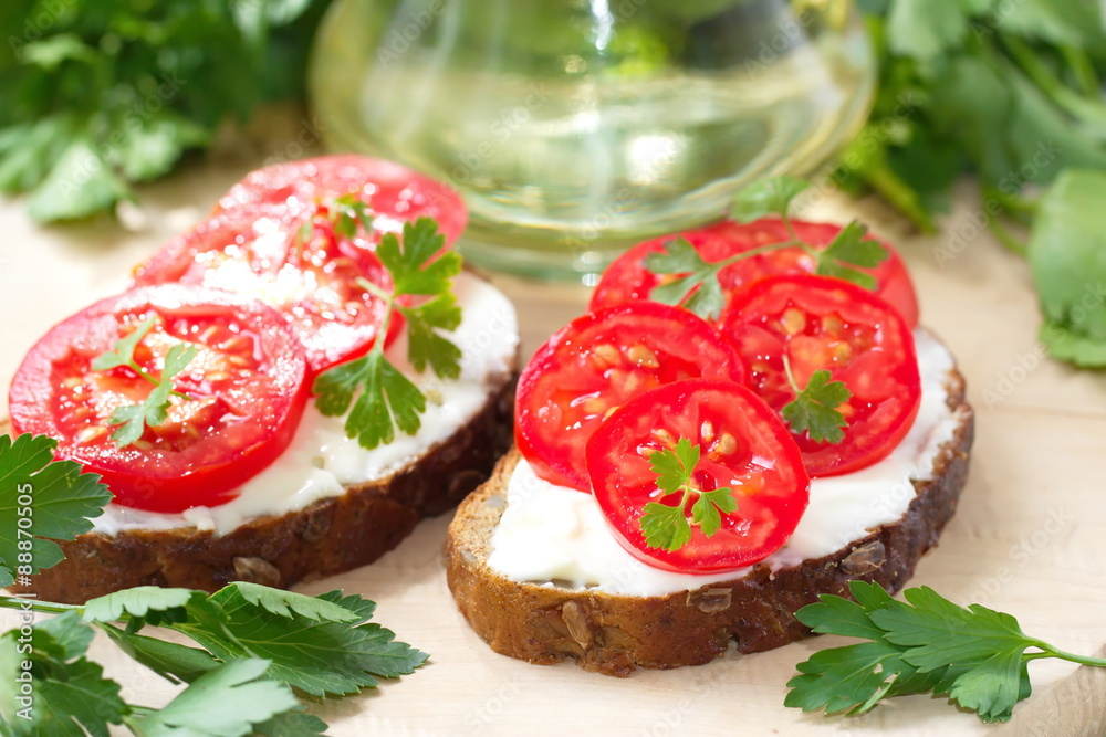 Sandwiches with creamy cheese and fresh tomatoes