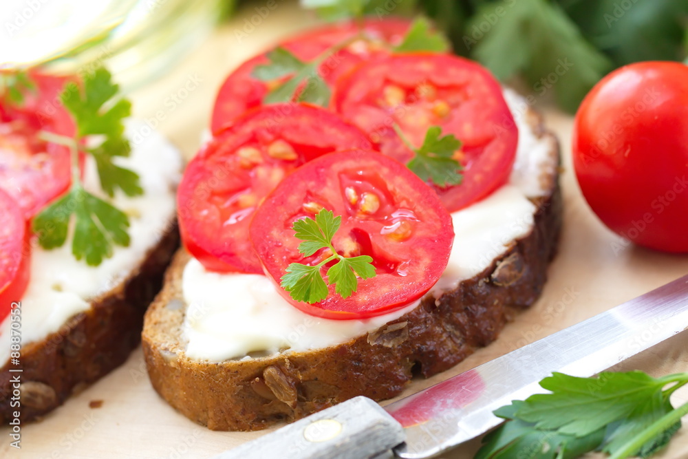 Sandwiches with creamy cheese and fresh tomatoes