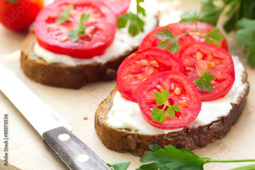 Sandwiches with creamy cheese and fresh tomatoes