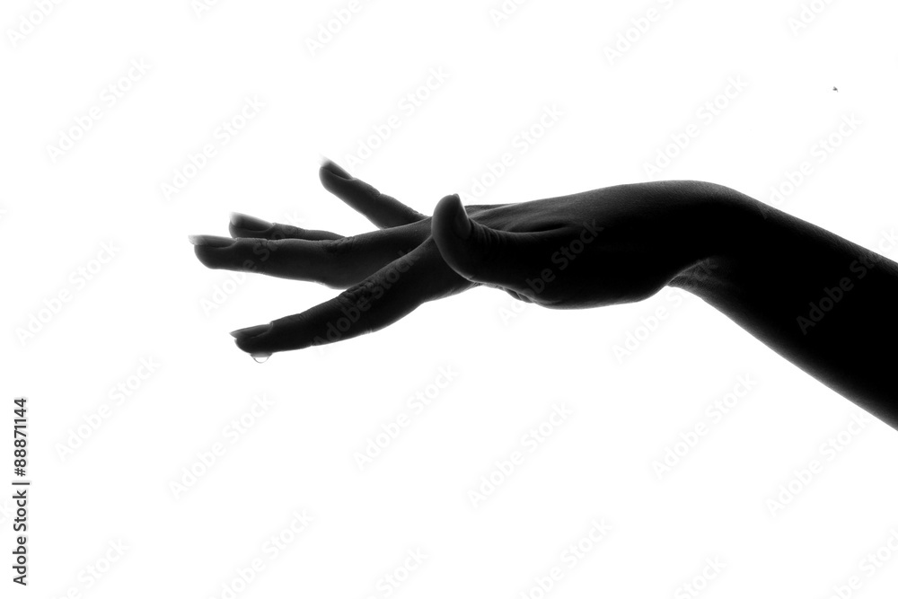 Obraz premium silhouette hand with water drop on the finger