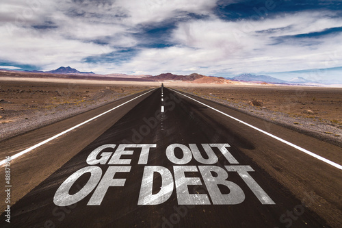 Get Out of Debt written on desert road