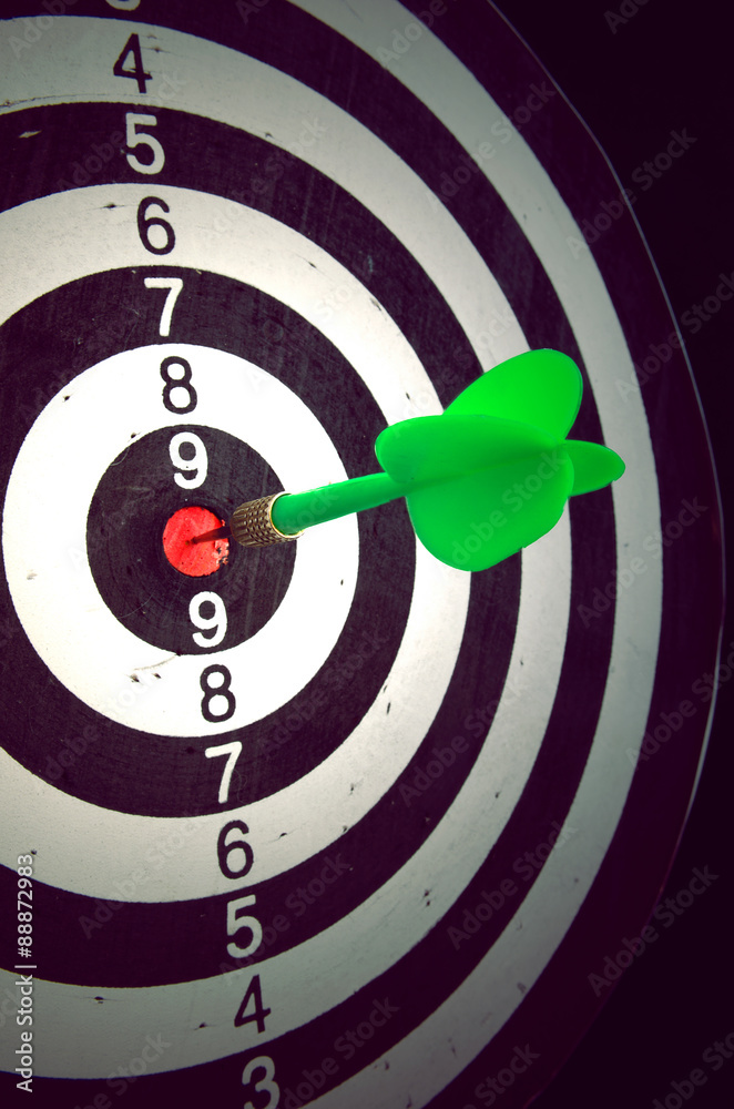Dart in darts target against a dark background Dart in darts target against a dark background