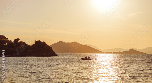 Beautiful Sunset on the sea, in the background mountains