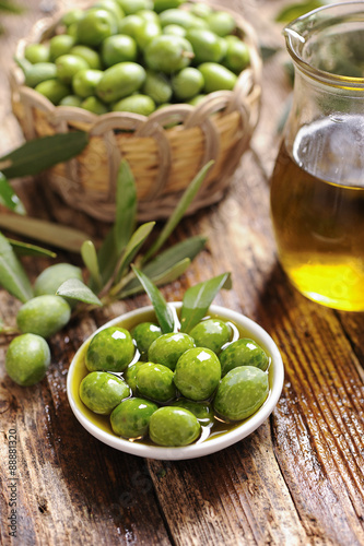 Olive oil with fresh olives 
