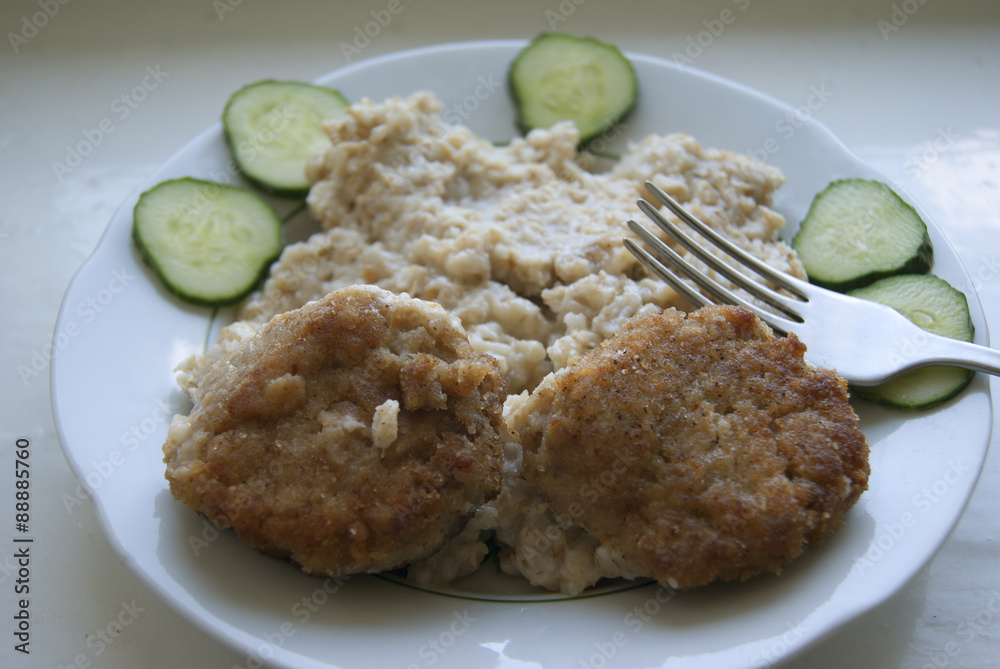 Two meatballs, with porridge and cucumbers Two meatballs, with porridge and cucumbers