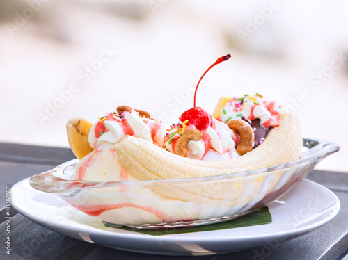 Banana split ice cream with whipped cream and cherry photo