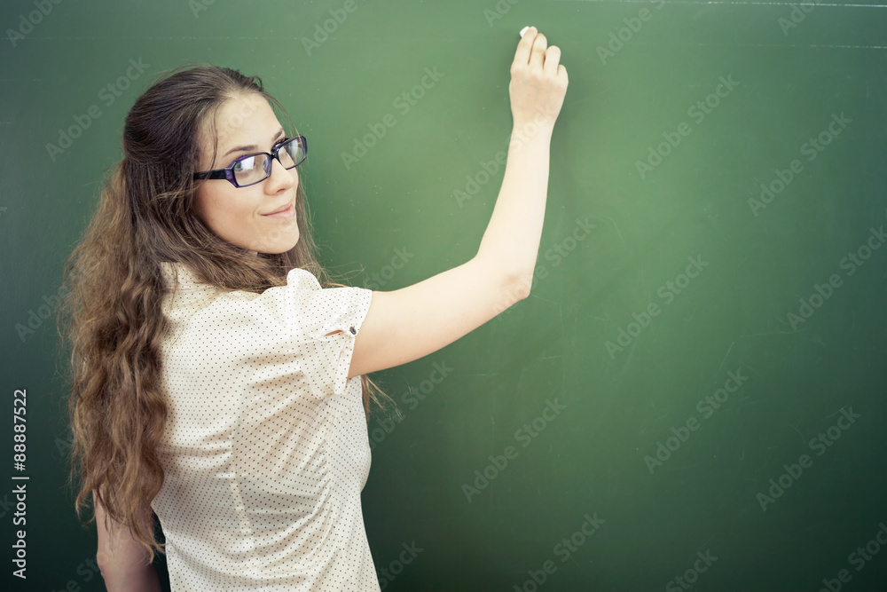 Teacher or student wrote on blackboard with chalk at classroom Teacher or student wrote on blackboard with chalk at classroom