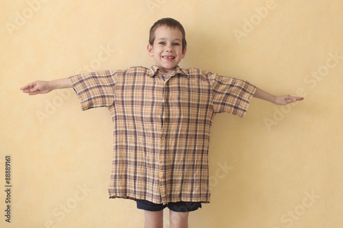 daddy's shirt. the boy in daddy's shirt which is too big for him