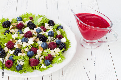 Summer refreshing mixed berry salad with pumpkin seeds, blue cheese, feta and sweet red raspberry vinaigrette photo